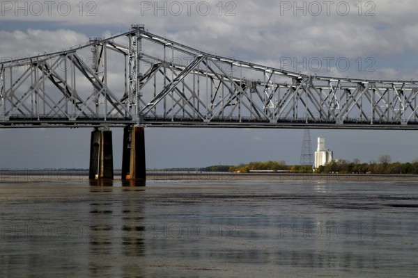 Steel bridge over a wide river with a view of a distant building, Natchez, Mississippi, USA
