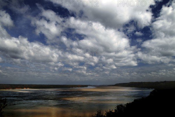 Wide river landscape with sandbanks under dramatic cloudy sky, Natchez, Mississippi, USA
