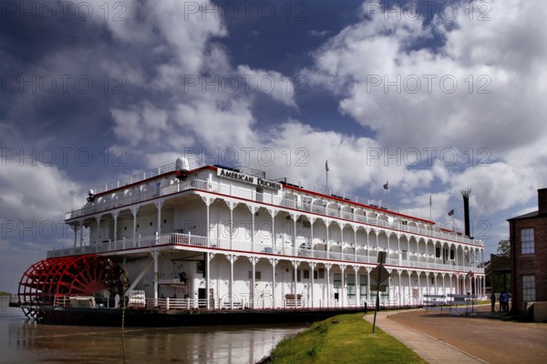 Large paddle steamer on the riverbank under a cloudy sky, Natchez, Mississippi, USA