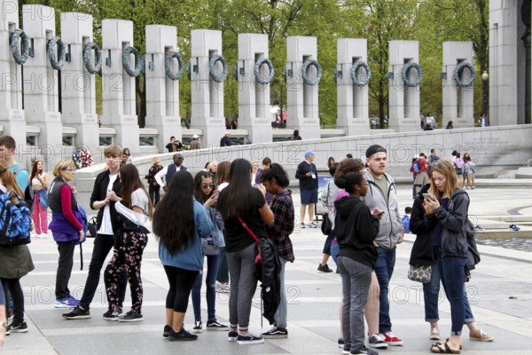 People group together at a memorial with tall pillars. The atmosphere is calm and respectful, Washington D.C, USA