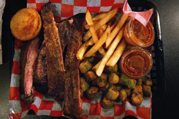 BBQ meal with ribs and side dishes on a tray in a restaurant, Savannah, Georgia, USA