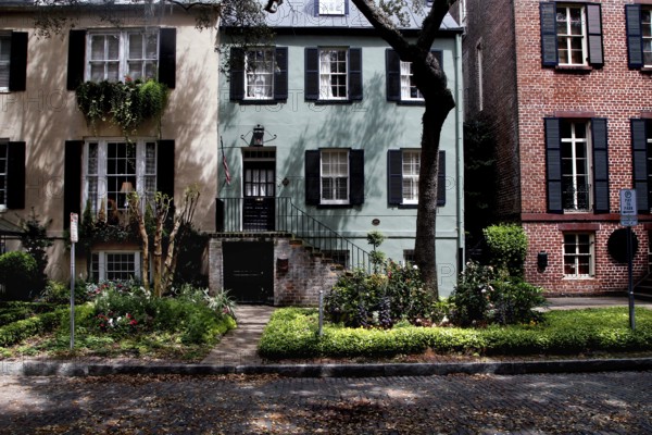 Small historic town house with colorful facades and well-kept front garden, Savannah, Georgia, USA