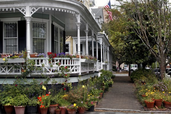 Large veranda of a historic house decorated with lush plants, Savannah, Georgia, USA