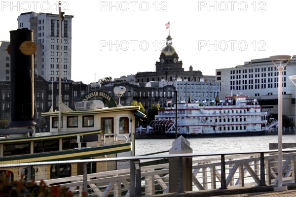 Historic ships on Savannah River flanked by impressive architecture, Savannah, Georgia, USA