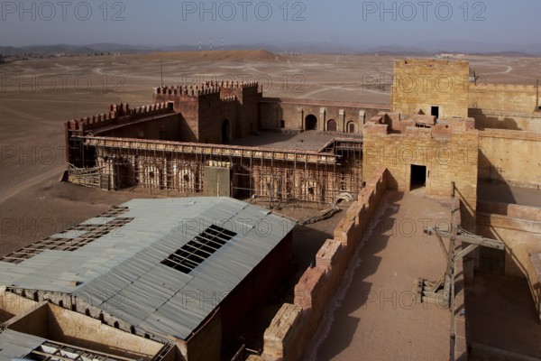 Panoramic view of a fortified complex in the desert, film set with extensive layout, Ouarzazate, Morocco