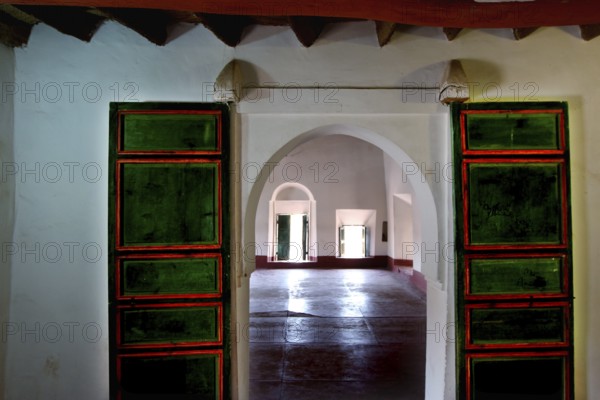 Interior view of a kasbah with colorful glass windows and arched doors, Ouarzazate, Kasbah Taourirt, Morocco