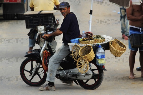 Street vendor on a motorcycle with baskets full of oysters in Oulidia, Oulidia, Doukkala-Abda, Morocco