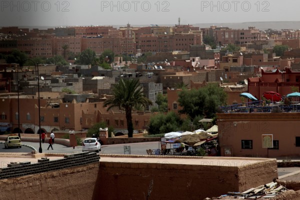 View of the city of Ouarzazate with palm trees and traditional architecture, Ouarzazate, Kasbah Taourirt, Morocco