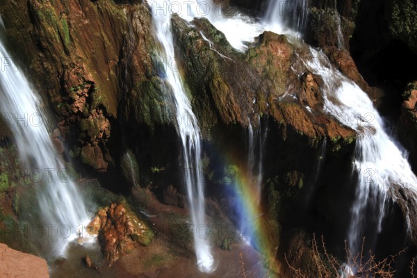 Ouzoud waterfalls with an impressive rainbow over the bubbling waters, Ouzoud, Morocco