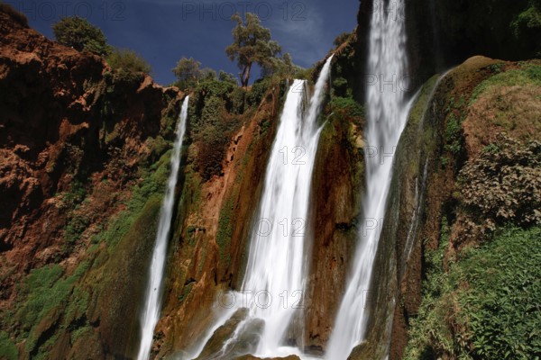 Majestic waterfalls of Ouzoud with thundering water surrounded by rocks and greenery, Ouzoud, Morocco