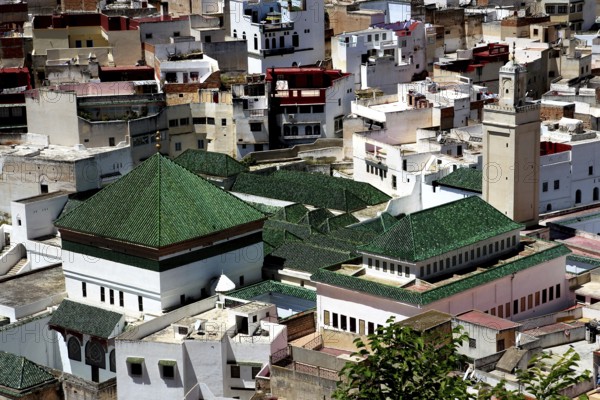 View over the roofs of Moulay Idris dominated by green tile roofs and minarets, Moulay Idris, Fès-Meknes, Morocco