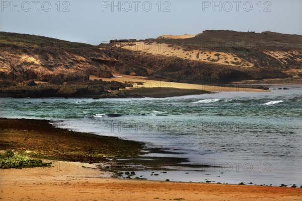 Wild coastal landscape on Oulidia beach with rough seas and windswept coast, Oulidia, Casablanca-Settat, Morocco