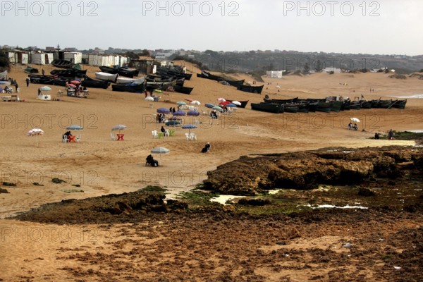 Extensive beach with visitors and lots of tents on the sand, Oulidia, Marrakesh-Safi region, Morocco