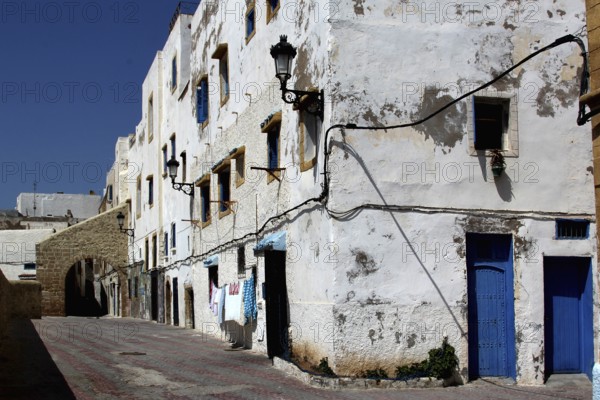 Textured white buildings with blue doors in Safi Medina, Safi, Doukkala-Abda, Morocco