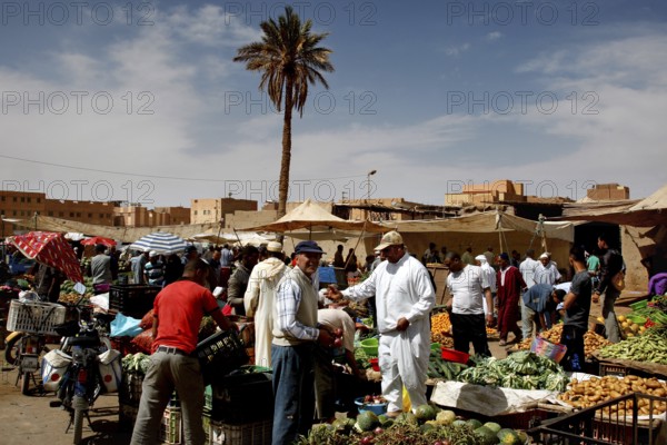 Talking to customers and shopping at the busy market in Rissani, Rissani, Niger, Morocco