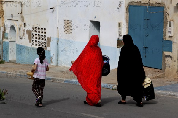 Two woman wearing traditional clothes in the old town of Sidi Ifni, Sidi Ifni, Souss-Massa, Morocco