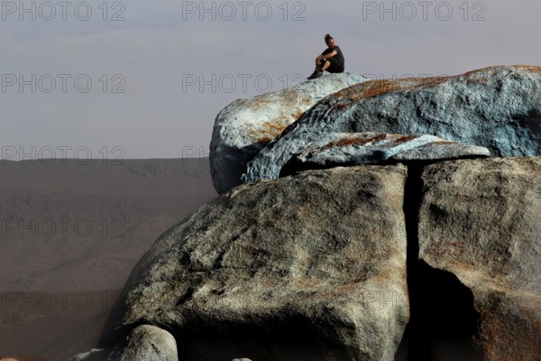 Person on the blue stones of artist Jean Verame with a wide view in Tafraoute, Tafraoute, Souss-Massa, Morocco