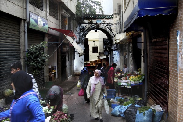 Bustling alley in Tangier's medina full of shops and market stalls, Tangier, Morocco
