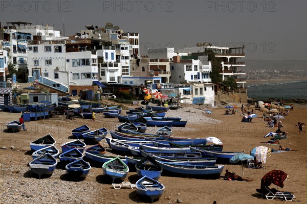 Fishing boats on Taghazout beach surrounded by buildings, Taghazout, Souss-Massa, Morocco