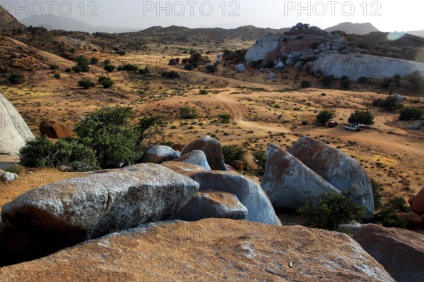 Wide desert landscape with painted blue stones by Jean Verame in Tafraoute, Tafraoute, Souss-Massa, Morocco