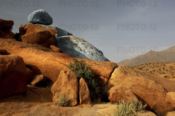 Blue and red rocks by Jean Verame in the desert landscape of Tafraoute, Tafraoute, Souss-Massa, Morocco
