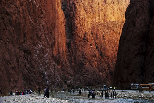 People explore the narrow Todra Gorge under light and shadow, Todra, gorge, narrowest point