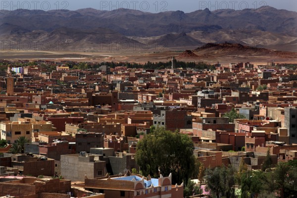 Overview of the city of Tinerhir with roofs and mountains behind them, Tinerhir, Morocco