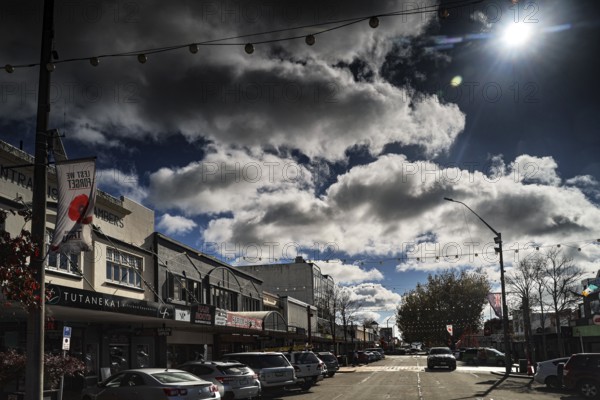 Busy Tutanekai Street in Rotorua with pedestrians and clouds under the bright blue sky, Rotorua, North Island, New Zealand