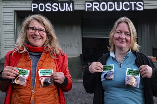 Two woman hold Possum products in front of the Possum Factory in Stratford, Stratford, New Zealand