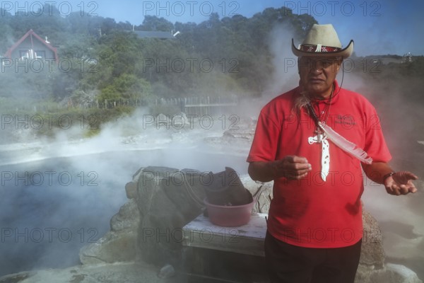 Maori guide shows how to prepare a hangi dish in Whakarewarewa, Rotorua, Bay of Plenty, New Zealand