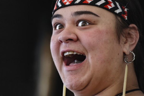 Woman with joyful facial expression in traditional dress, Rotorua, Whakarewarewa, New Zealand