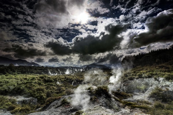 Impressive Waiotapu geothermal area with rising steam and dramatic clouds, Waiotapu, Bay of Plenty, New Zealand