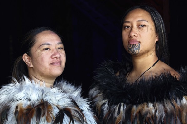 Two woman in traditional Maori garments pose for a portrait, Waitangi, New Zealand