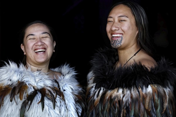 Two laughing woman in Maori robes radiate joy and community, Waitangi, New Zealand