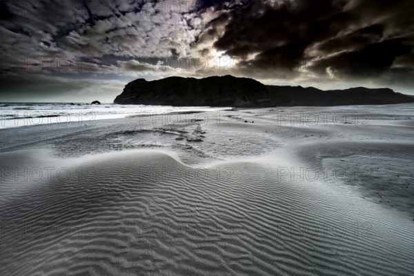 Rough sand dunes on Wharariki Beach in dramatic skies at dusk, zero