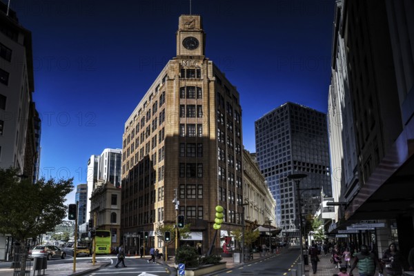 Historic building with clock tower and modern buildings in clear skies on Lambton Quay, Wellington, New Zealand