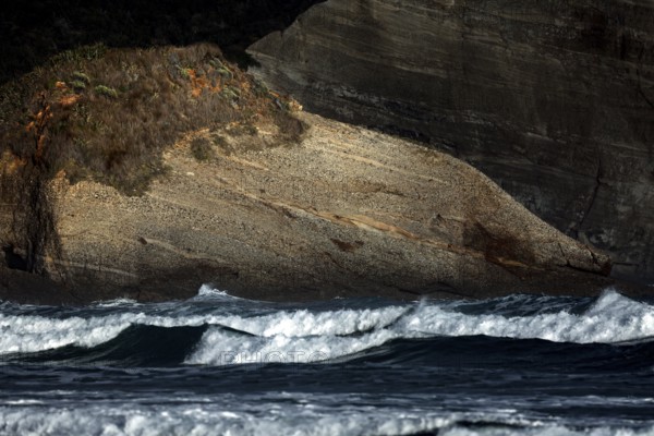 Natural, rough rocks on Wharariki Beach, washed by the sea, Wharariki, Tasman, New Zealand