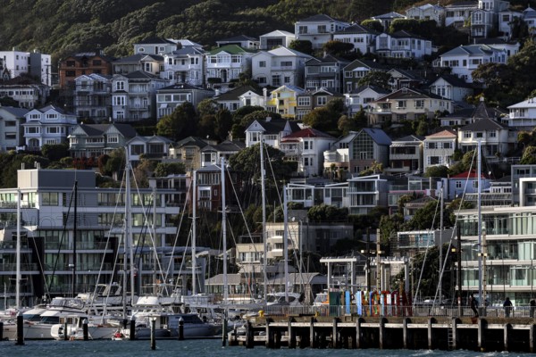 Houses on a hill with harbour and boats in the Wellington district, Wellington, North Island, New Zealand