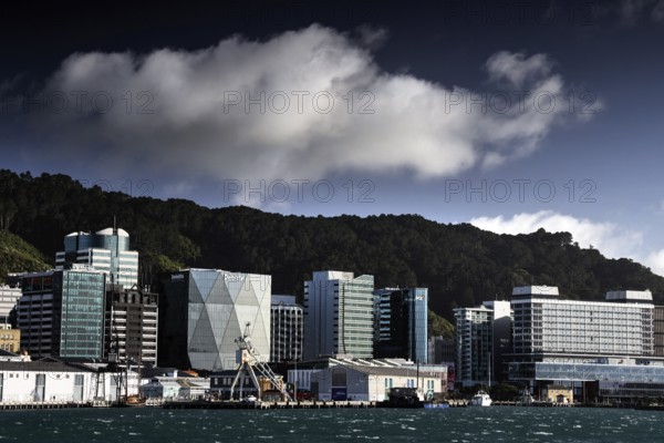 Modern building front on Wellington Waterfront under dramatically cloudy sky, Wellington, New Zealand