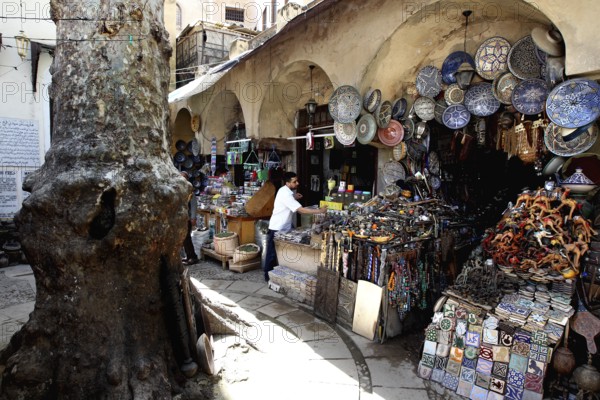 Market scene in Place Neijarine with artisanal ceramics and traditional goods, Fez, Fès-Boulemane, Morocco