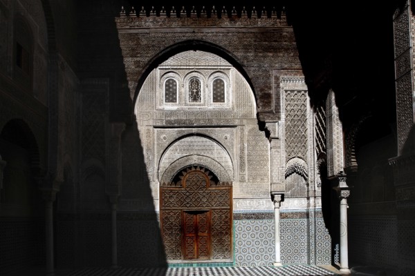 Magnificent Medersa Attarine architecture with ornate wooden doors and decorations, Fez, el-Bali, Morocco