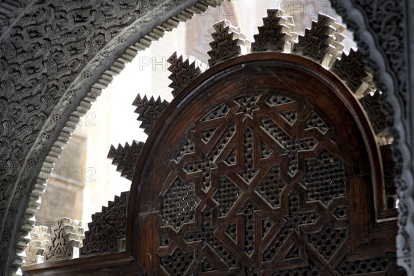 Traditional wooden door with complex Islamic decorations in Medersa Attarine, Fez, Fès-Boulemane, Morocco