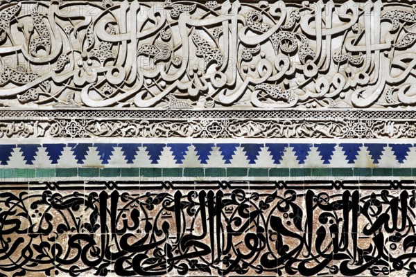 Detailed mosaics and arabesques with artistic Arabic characters in the Medersa Attarine, Fez, el-Bali, Morocco
