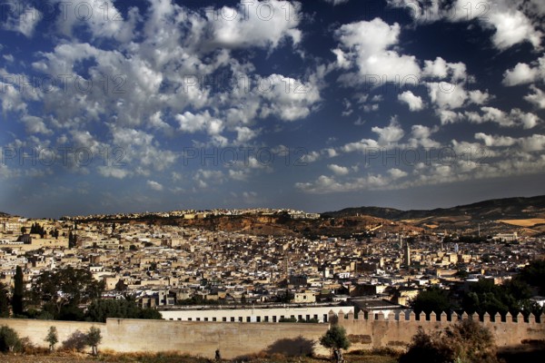 Panoramic view of Fez from the south with a mix of ancient architecture under a picturesque sky, Fez, el-Bali, Morocco
