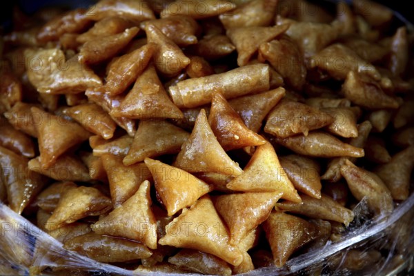 Traditional Moroccan sweets in golden brown color in close-up, Fez, Fez el Bali, Morocco