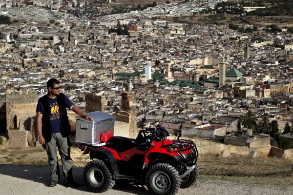 Man with quad bike in view of Fez from the Merinid Tombs, Fez, Fez el Bali, Morocco