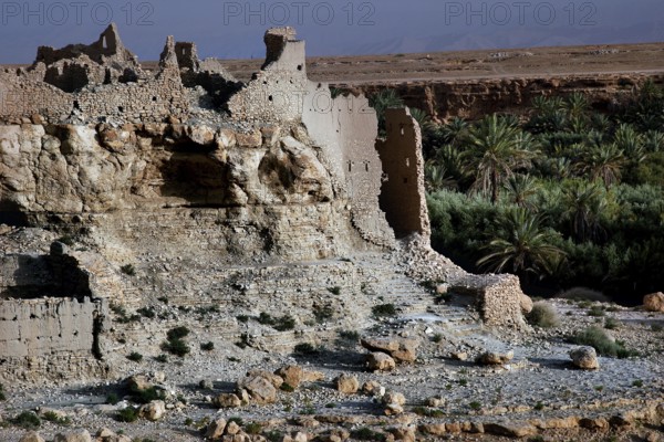 Dilapidated kasbah overlooking green vegetation and barren surroundings, Meski, Morocco
