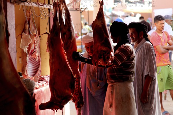People buy meat in the meat souk of Guelmim, Guelmim, Guelmim-Oued Noun, Morocco