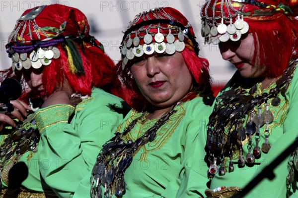 Traditional Berber dancers in colorful clothes at the Fête des Roses, El Kelâa m'Gouna, Morocco