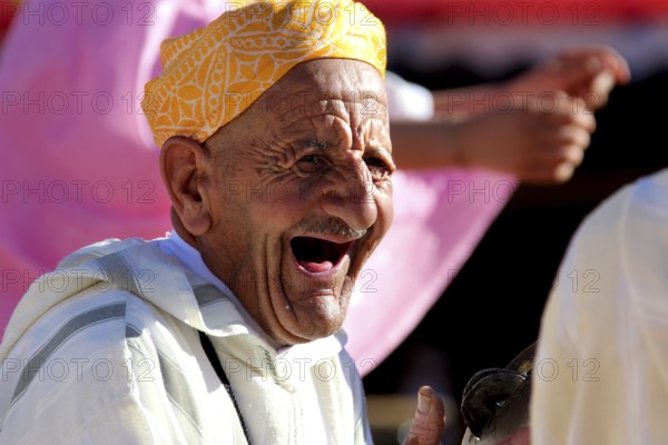An elderly man laughs heartily during the traditional Berber festival, Ma El Kelâa m'Gouna, Fête des Roses, Berber Dances